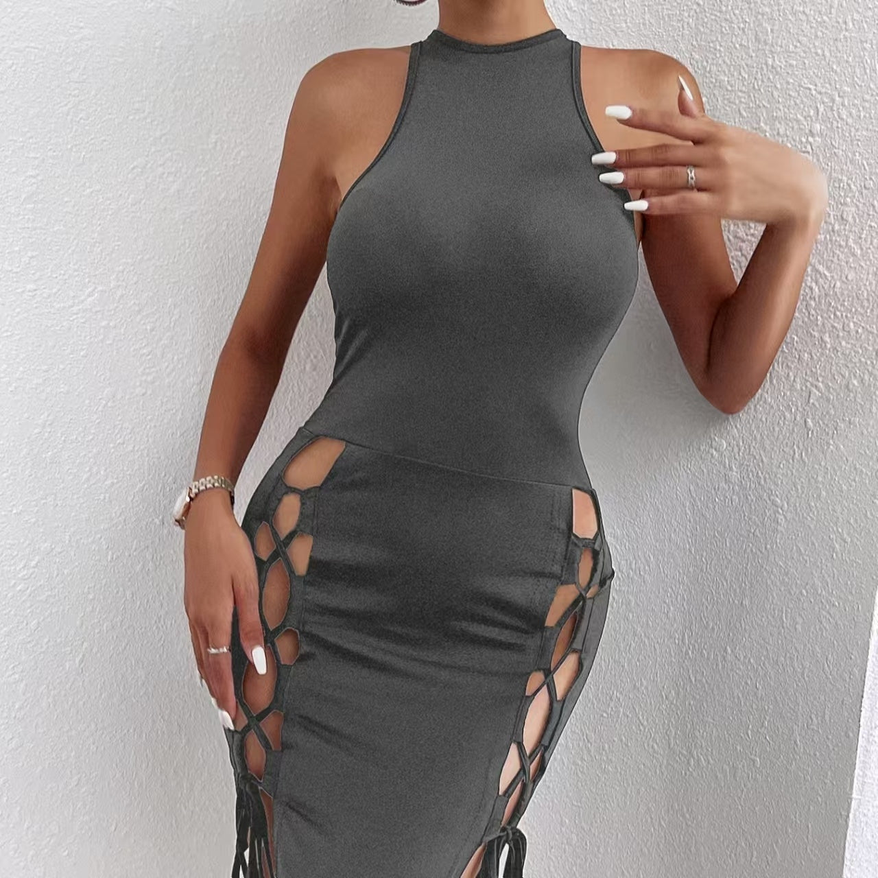 Back angle of solid-color bodycon mini dress showing thigh slit and cross-tie closure