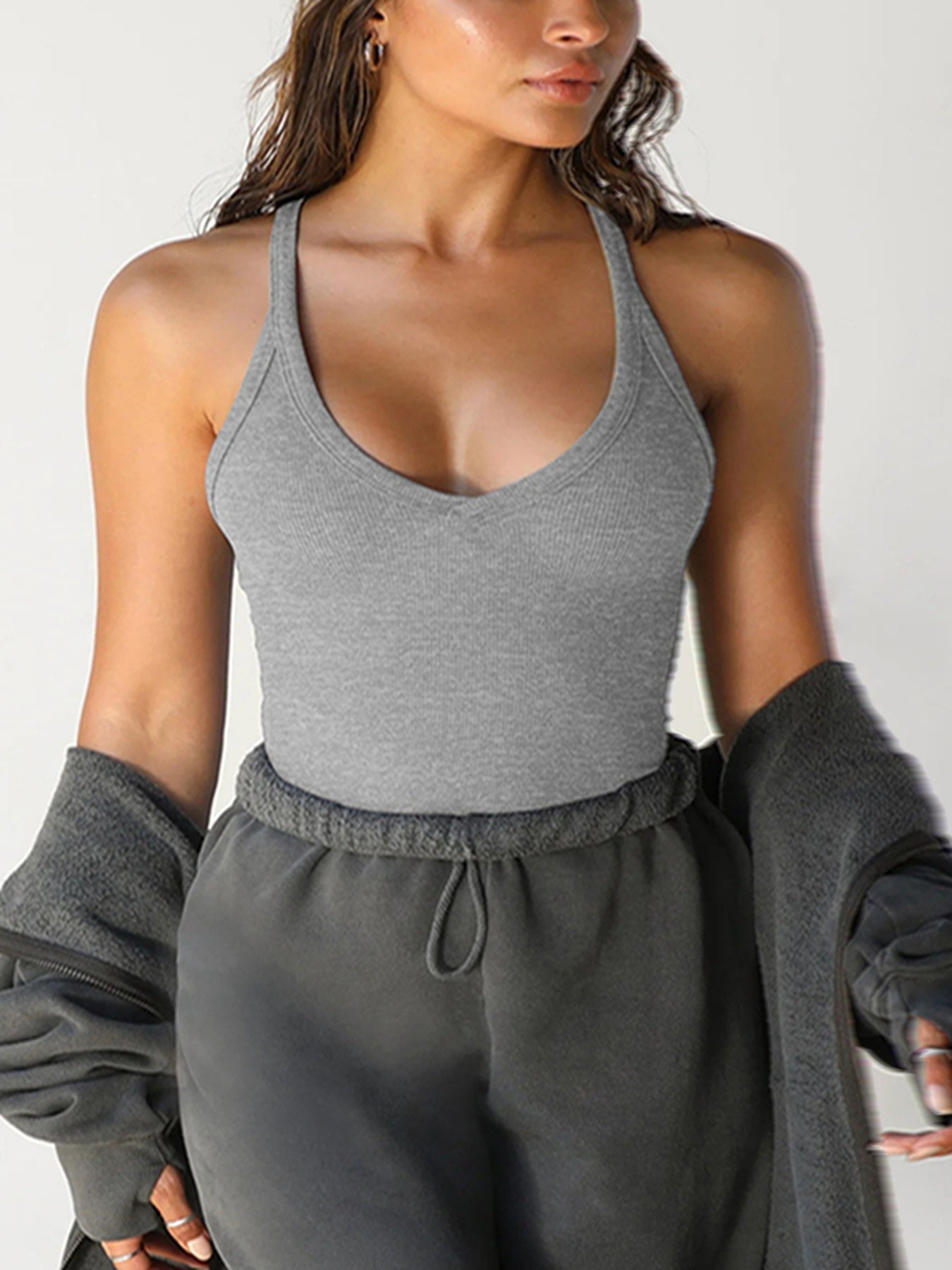 Contemporary women’s knitwear featuring a clean, modest vest-over-top style.