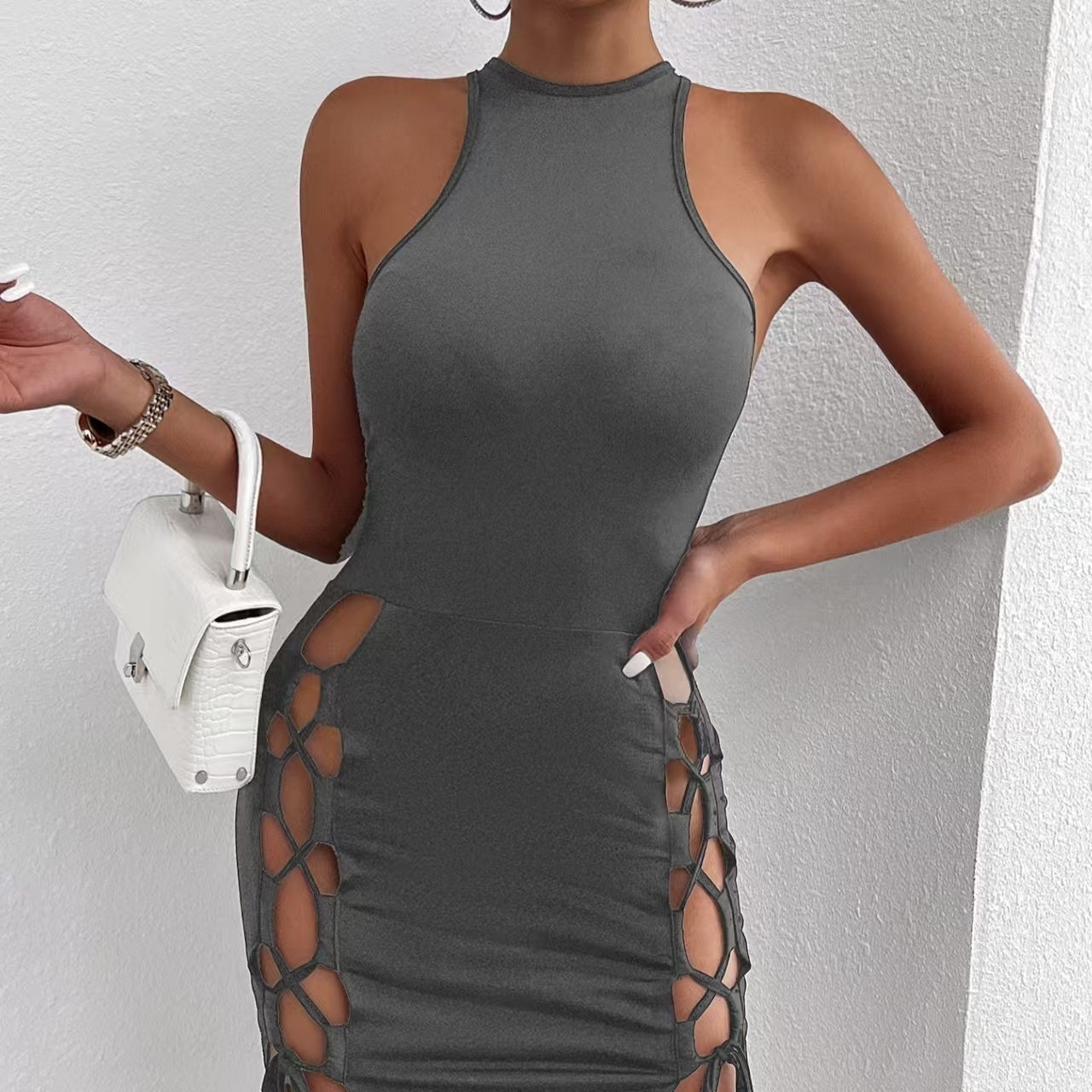 Solid-color sleeveless mini dress with thigh slit & cross-tie laid flat - bodycon silhouette