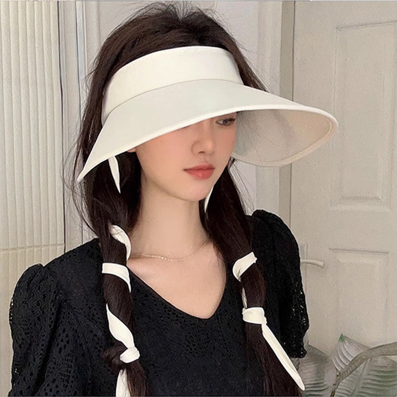 Woman wearing summer cycling hat with ponytail opening.