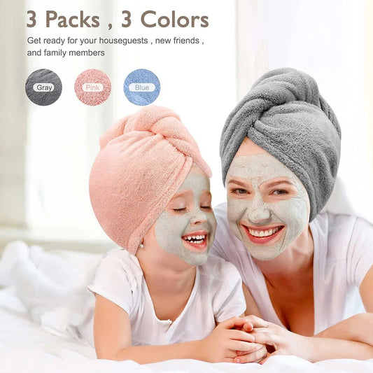 Light gray microfiber hair turban, charcoal satin pillowcases, and beige detangling brush laid flat